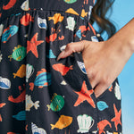 Close-up of side pocket on navy seaside novelty print fit-and-flare dress