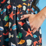 Close-up of side pocket on navy seaside novelty print fit-and-flare dress