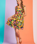Woman wearing colorful tropical print fit-and-flare mini dress with square neckline and belt