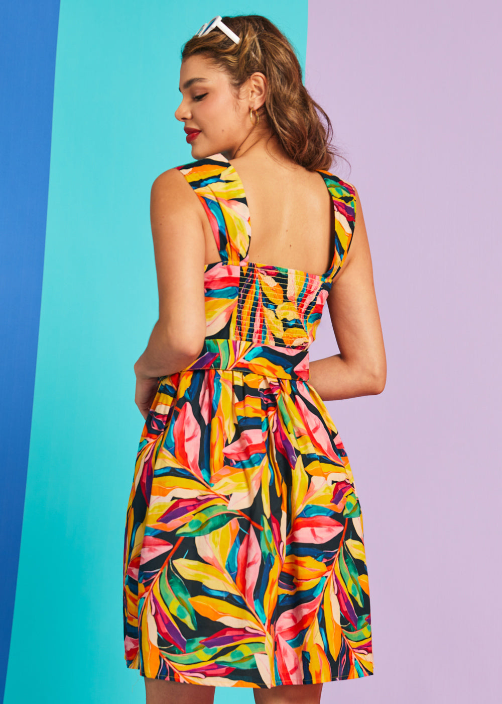 Back view of tropical print fit-and-flare dress with smocked back panel