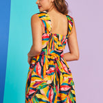 Back view of tropical print fit-and-flare dress with smocked back panel