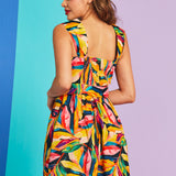 Back view of tropical print fit-and-flare dress with smocked back panel