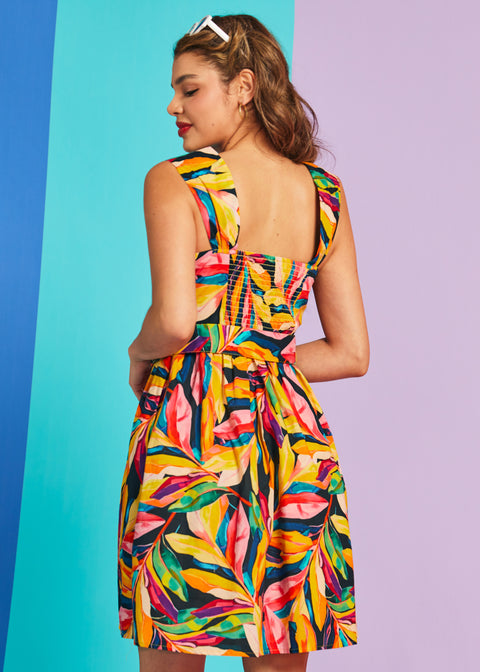 Back view of tropical print fit-and-flare dress with smocked back panel
