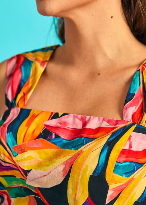 Close-up of square neckline on colorful tropical print sleeveless dress