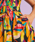 Close-up of matching belt and pocket detail on tropical print dress
