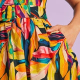 Close-up of matching belt and pocket detail on tropical print dress