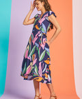Side view of tropical print wrap-style midi dress with flutter sleeves and pockets