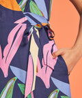 Close-up of adjustable side tie waist detail on tropical print midi dress