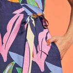 Close-up of adjustable side tie waist detail on tropical print midi dress