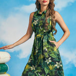 Woman wearing vintage-inspired tropical floral shirt dress with collared neckline