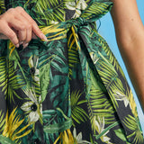 Close-up of waist tie detail on tropical palm print resort dress