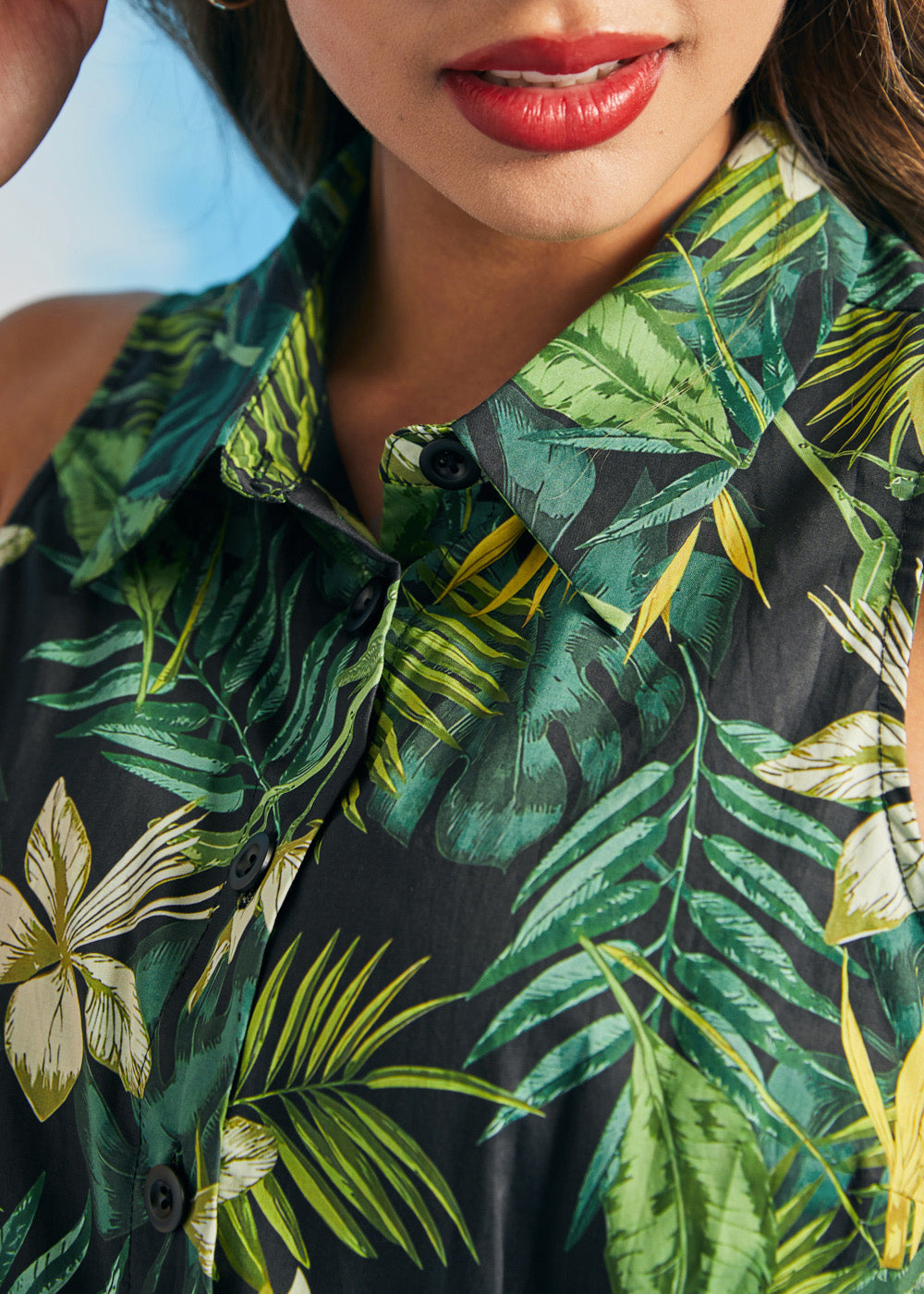 Close-up of tropical botanical print and collared neckline on sleeveless shirt dress