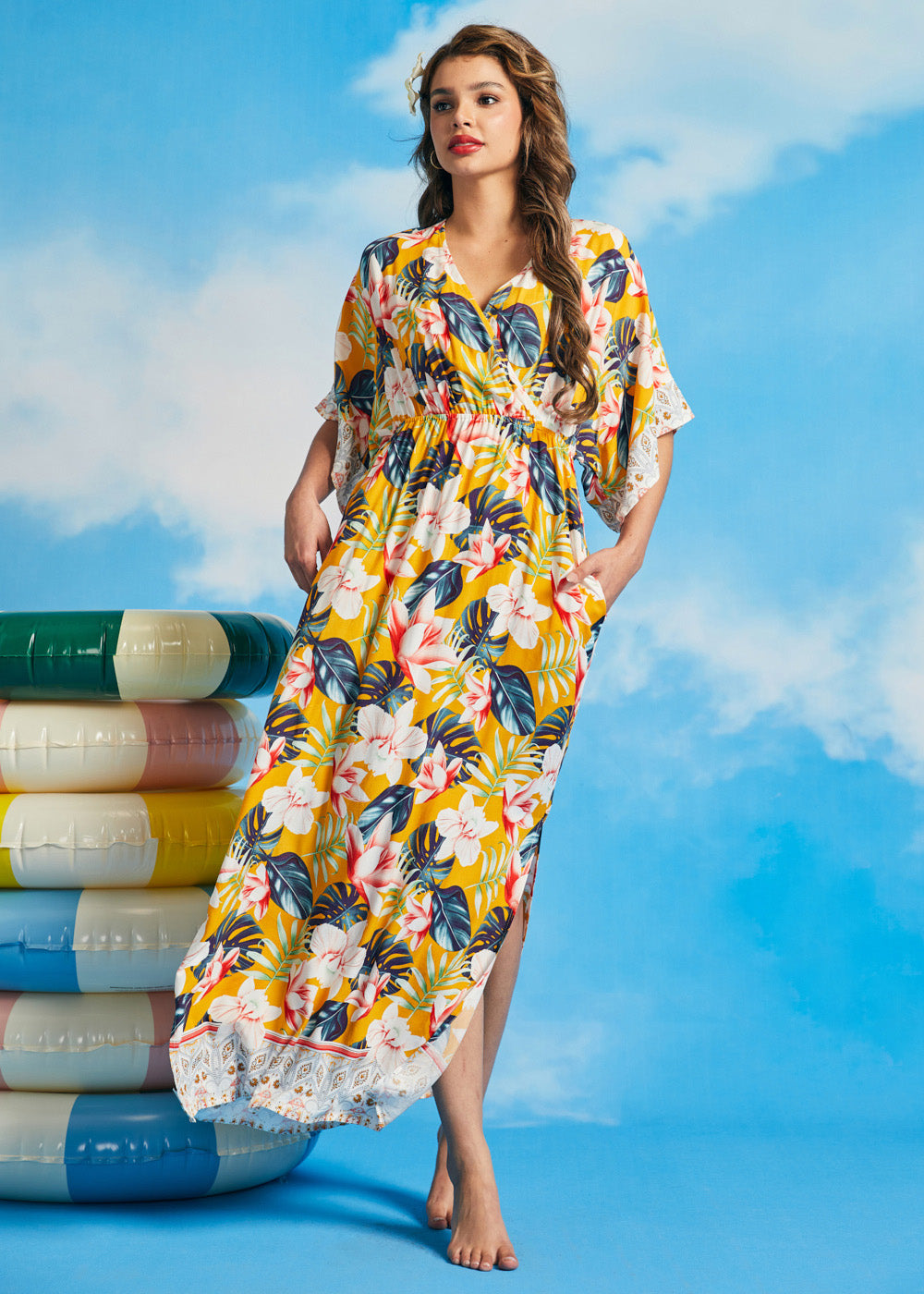 Woman in a yellow floral dress with pockets