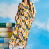 Woman in a yellow floral dress with pockets