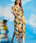 Woman wearing tropical floral maxi dress with kimono sleeves and faux-wrap neckline