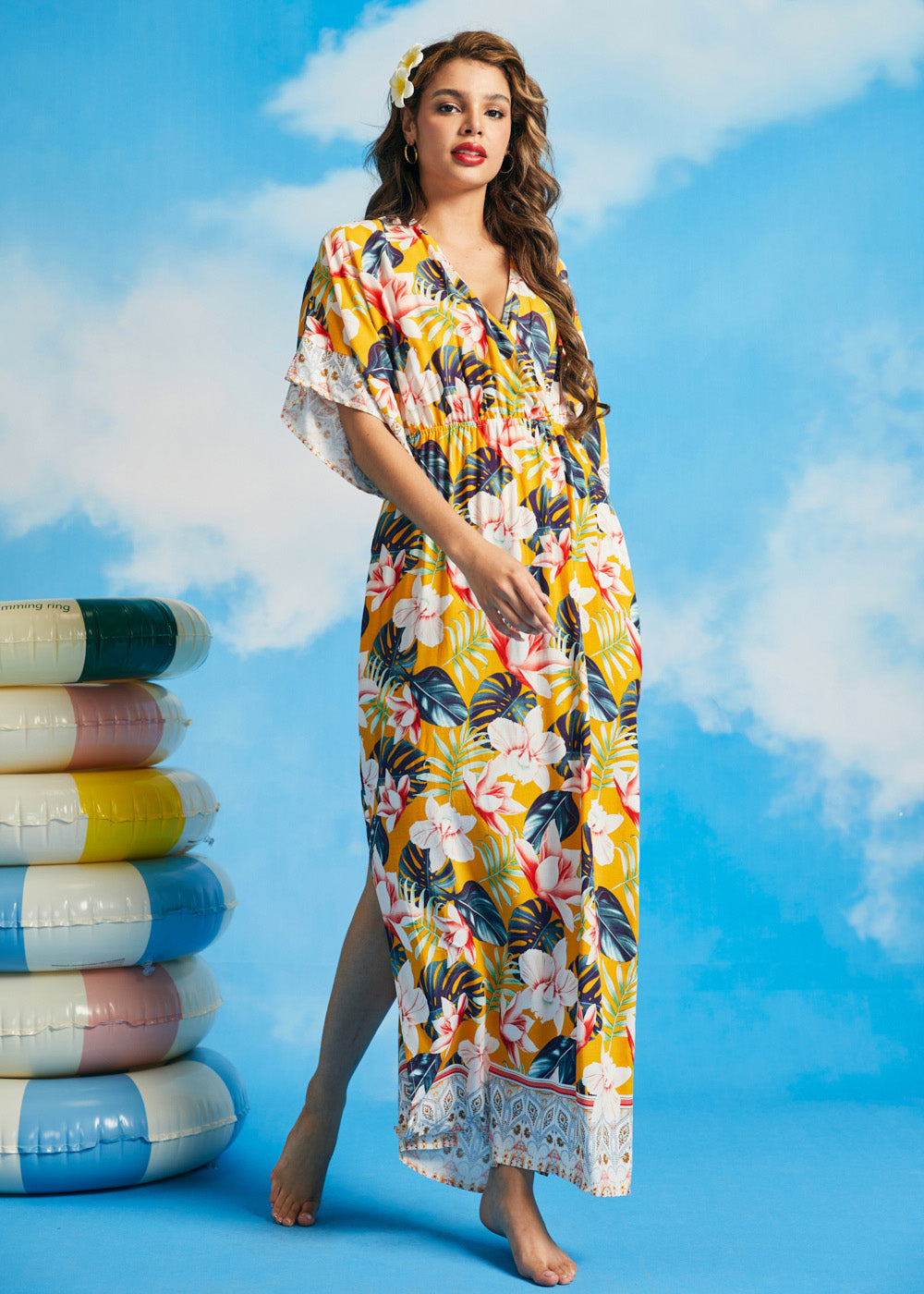 Woman wearing tropical floral maxi dress with kimono sleeves and faux-wrap neckline