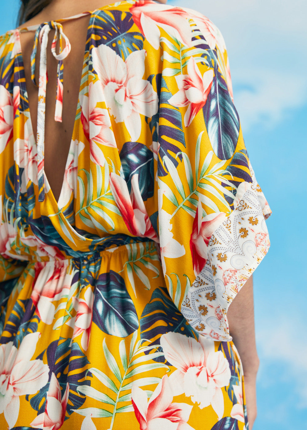 Close-up of tropical floral print and kimono sleeve border detail on maxi dress