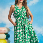 Green sleeveless faux-wrap midi dress with ivory seashell novelty print and side pockets