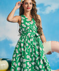 Vintage-inspired green vacation dress with seashell print and twirl-ready silhouette