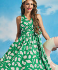 Front view of green sleeveless seashell print midi dress with wrap-style bodice