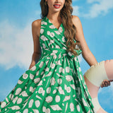 Front view of green sleeveless seashell print midi dress with wrap-style bodice