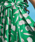 Close-up of adjustable waist tie on green seashell print cotton midi dress