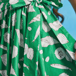 Close-up of adjustable waist tie on green seashell print cotton midi dress