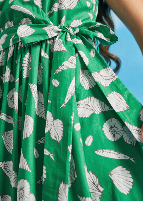 Close-up of adjustable waist tie on green seashell print cotton midi dress