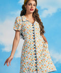 Woman wearing novelty sardine print vintage-inspired shirt dress with short sleeves and contrast piping