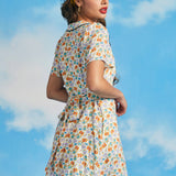 Back view of novelty sardine print mini dress with removable waist tie