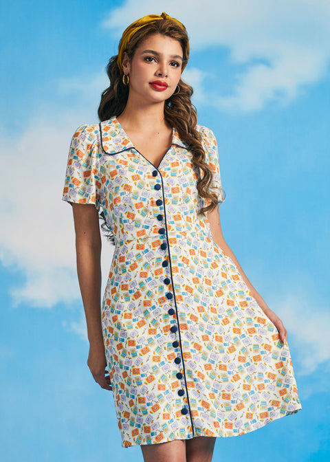 Woman wearing vintage-inspired sardine print dress with pockets and button front