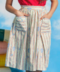 Woman wearing full midi dirndl skirt with starfish stripe print and oversized patch pockets