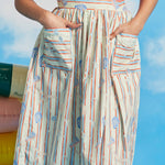 Woman wearing full midi dirndl skirt with starfish stripe print and oversized patch pockets