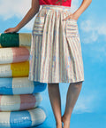 Woman modeling vintage-style gathered dirndl skirt with shell and starfish novelty print