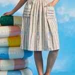 Woman modeling vintage-style gathered dirndl skirt with shell and starfish novelty print