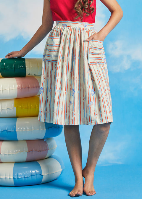 Woman modeling vintage-style gathered dirndl skirt with shell and starfish novelty print