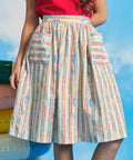 Close-up of cotton dirndl skirt with gathered waist and oversized patch pockets in starfish stripe print