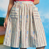 Close-up of cotton dirndl skirt with gathered waist and oversized patch pockets in starfish stripe print