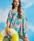 Front view of pink tropical caftan cover-up with breezy oversized fit