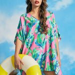 Front view of pink tropical caftan cover-up with breezy oversized fit