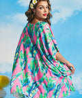 Back view of tropical leaf print caftan with flowing silhouette and high-low hem