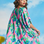 Back view of tropical leaf print caftan with flowing silhouette and high-low hem