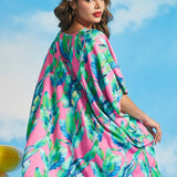 Back view of tropical leaf print caftan with flowing silhouette and high-low hem