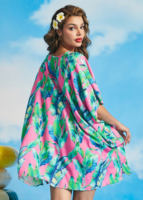 Back view of tropical leaf print caftan with flowing silhouette and high-low hem