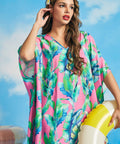 Tropical pink caftan resort wear with watercolor palm leaf print and wide draped sleeves