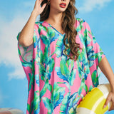 Tropical pink caftan resort wear with watercolor palm leaf print and wide draped sleeves