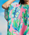 Detail of wide draped sleeve and lightweight woven fabric on tropical caftan