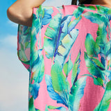 Detail of wide draped sleeve and lightweight woven fabric on tropical caftan