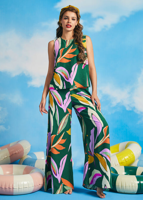Woman wearing colorful tropical print sleeveless shell top with extra-wide palazzo pants