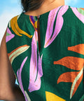 Close-up of round neckline and lightweight woven fabric on tropical print top